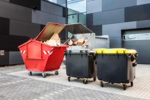 Operatives loading mixed commercial waste into a van in a London street